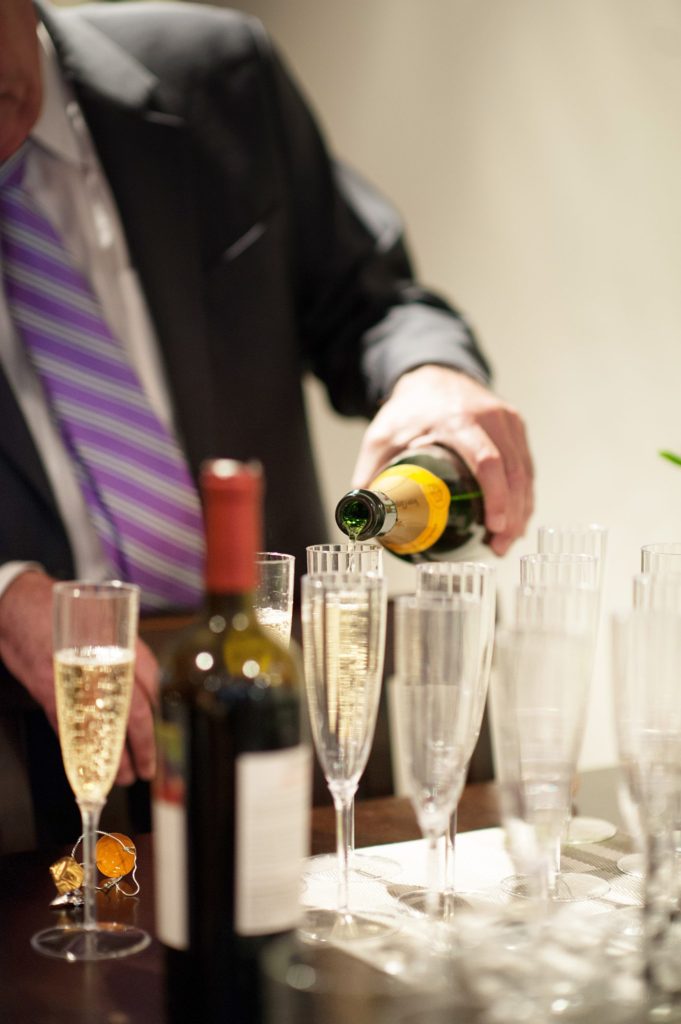 Champagne toast during a small Brooklyn wedding elopement in NYC during Fall. Photos by Mikkel Paige Photography with a ceremony held at Fort Greene Park and reception at the couple's apartment across the street.