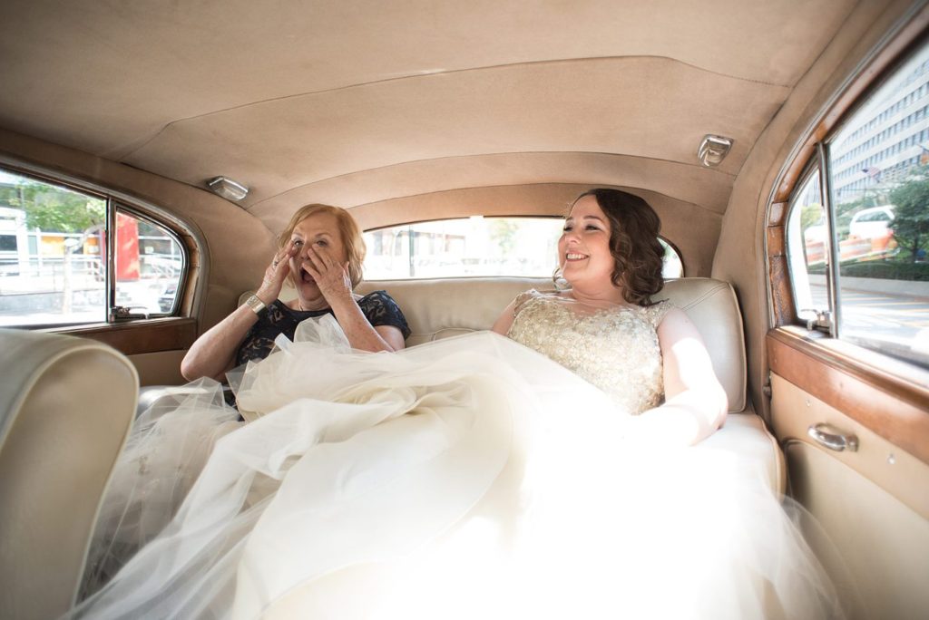 The bride transported to her 501 Union wedding in Brooklyn in a vintage white Rolls Royce with her mom. Photos by Mikkel Paige Photography.