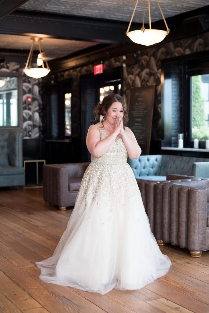A 501 Union wedding in Brooklyn with photos by Mikkel Paige Photography. The bride reacts to an emotional first look with her future wife.