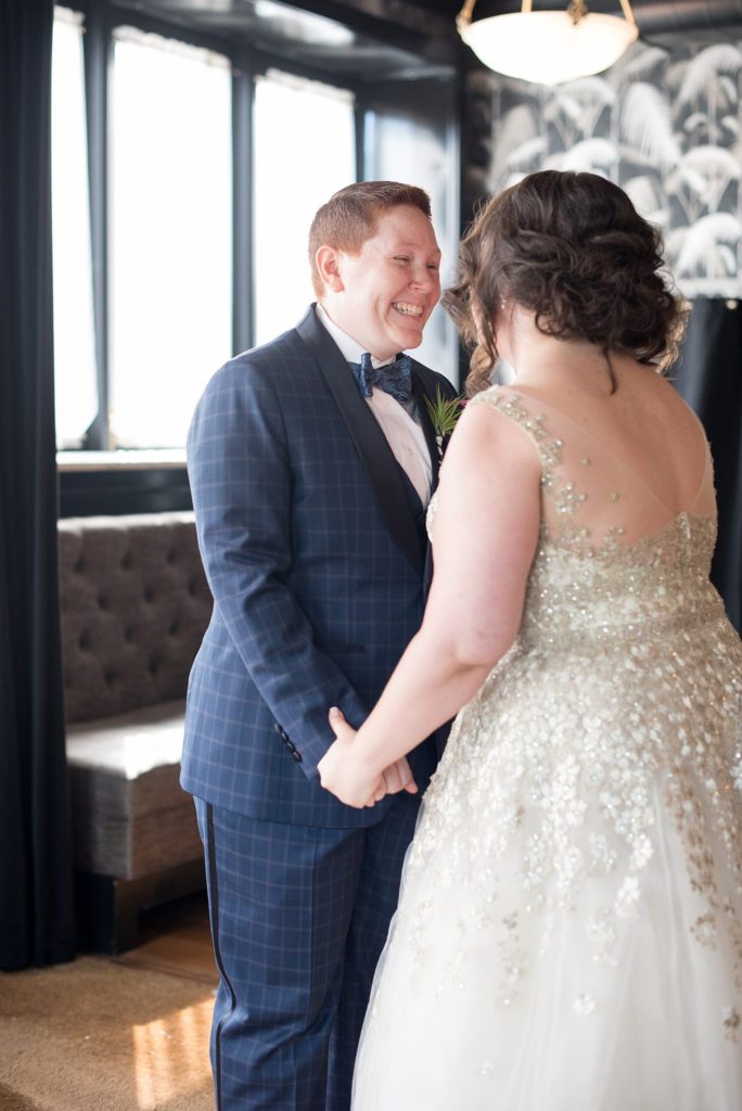 A 501 Union wedding in Brooklyn with photos by Mikkel Paige Photography. The bride reacts to an emotional first look with her future wife.