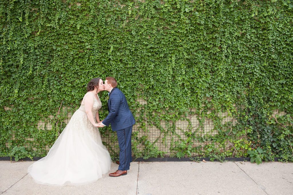 A 501 Union wedding in Brooklyn with photos by Mikkel Paige Photography. Two brides kiss on their wedding day.