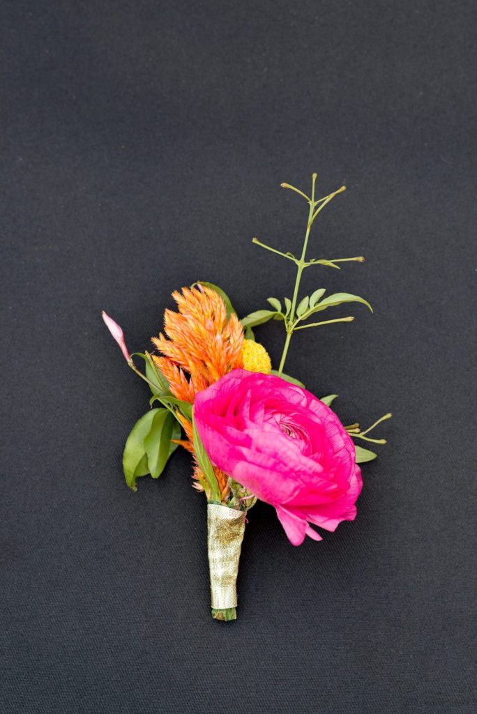 A 501 Union wedding with photos by Mikkel Paige Photography. A colorful pink and orange boutonniere by August Sage and Violet. Planning by Ashley Chamblin Events.