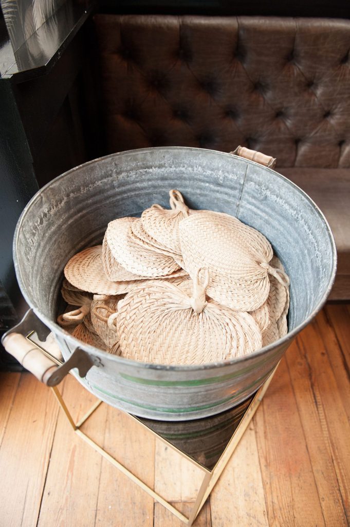 A 501 Union wedding with photos by Mikkel Paige Photography of the bamboo fans for the ceremony.