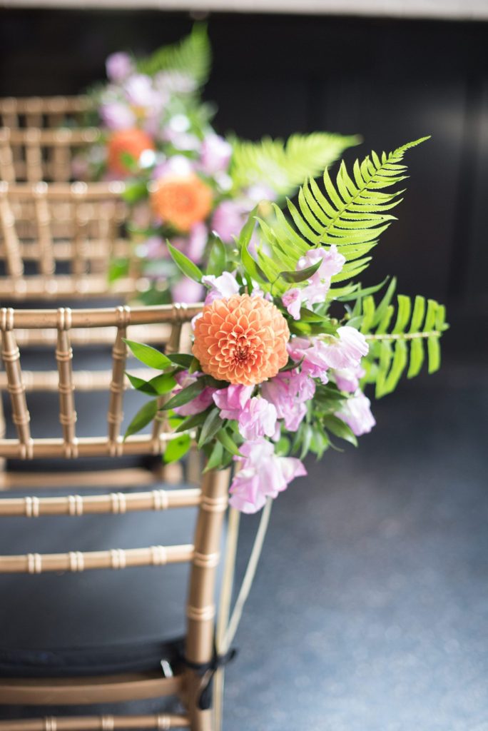 A 501 Union wedding with photos by Mikkel Paige Photography of the ceremony's pink sweet pea flowers, fern and orange dahlias by August Sage and Violet in Brooklyn, NY.