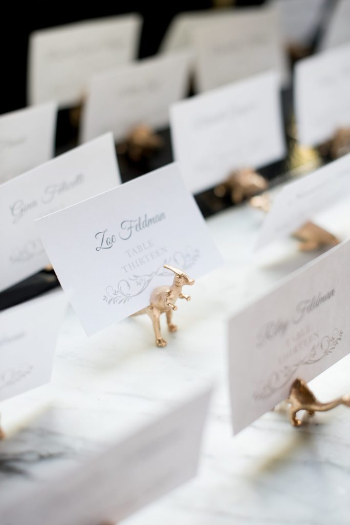 501 Union wedding with photos by Mikkel Paige Photography of the escort cards in gold dinosaurs.