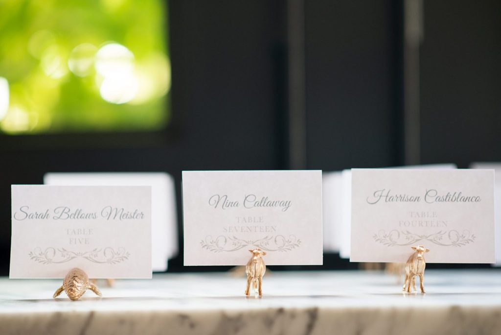 501 Union wedding with photos by Mikkel Paige Photography of the escort cards in gold dinosaurs.