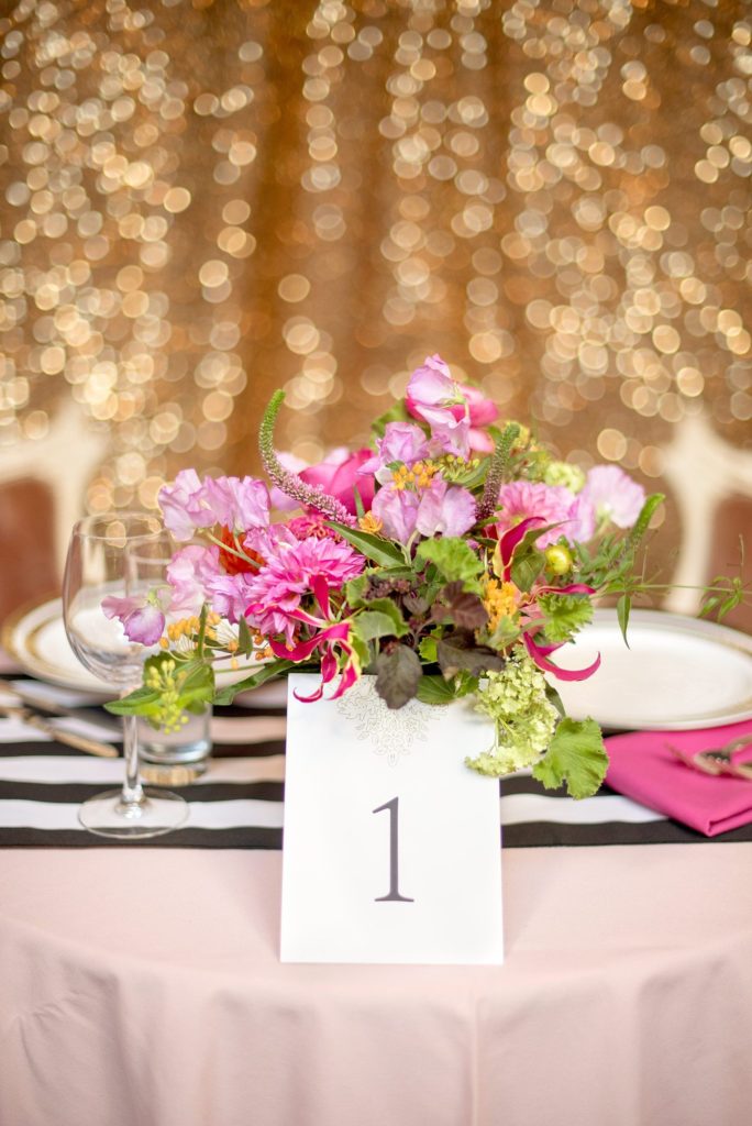 501 Union wedding with photos by Mikkel Paige Photography of the sweetheart table. Colorful flowers by August Sage and Violet and planning by Ashley Chamblin Events.