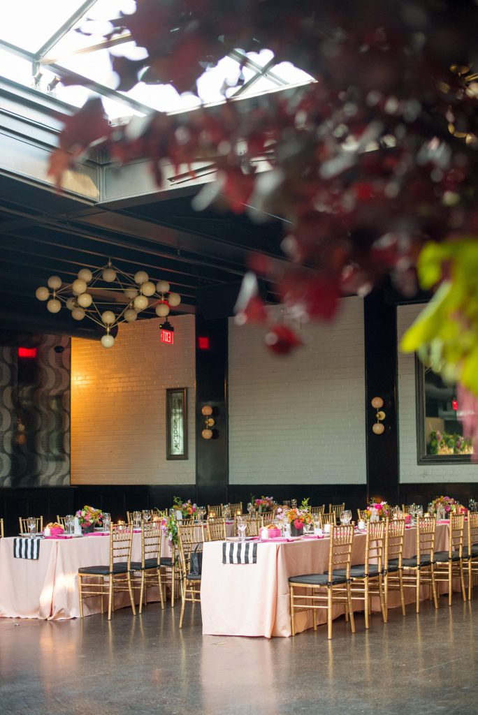 501 Union wedding with photos by Mikkel Paige Photography. The reception in Brooklyn, NY was lined with rectangular tables covered in pink linens, with vibrant flowers by August Sage and Violet and planning by Ashley Chamblin Events.