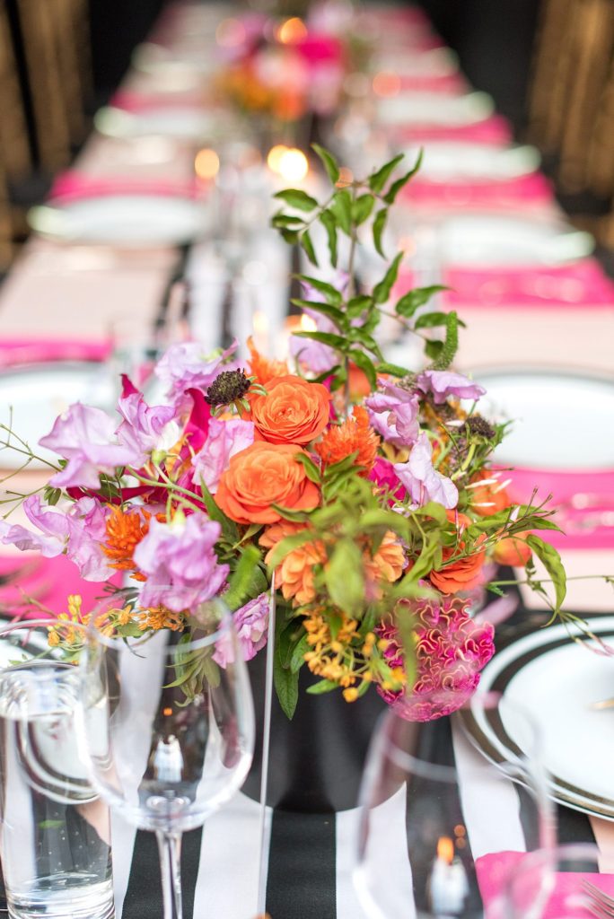 501 Union wedding with photos by Mikkel Paige Photography. The reception in Brooklyn, NY was lined with rectangular tables covered in pink linens, with vibrant flowers by August Sage and Violet and food by Ryan Brown Catering.