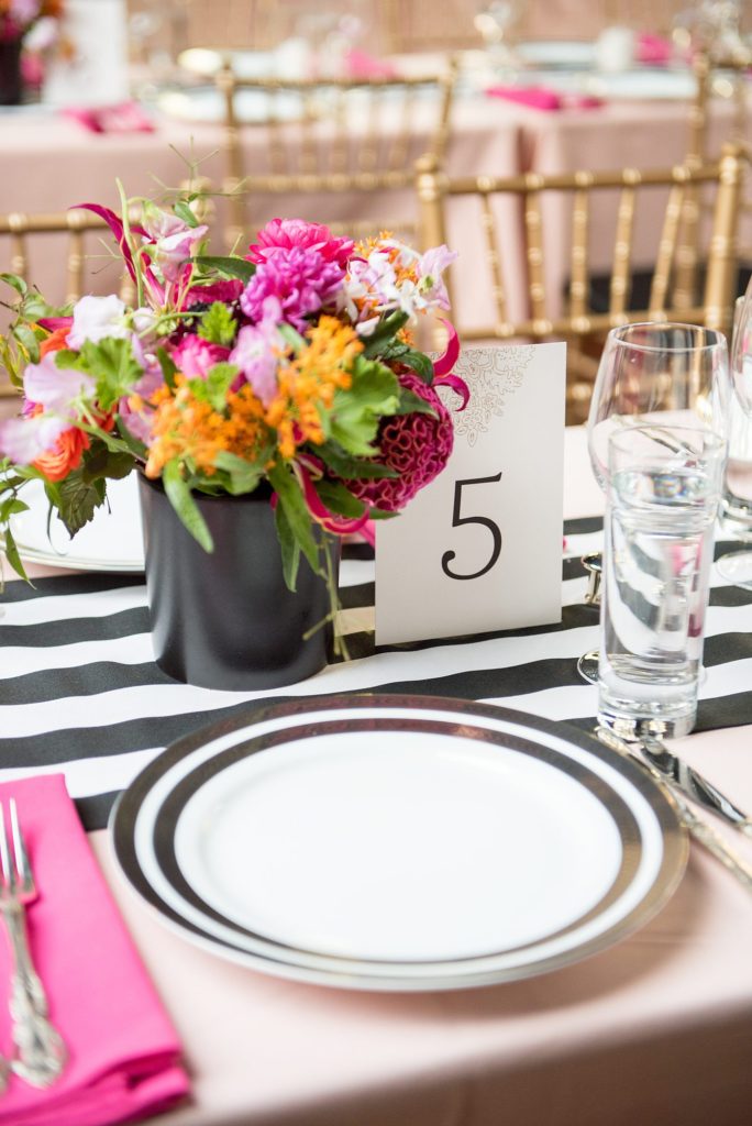 501 Union wedding with photos by Mikkel Paige Photography. The reception in Brooklyn, NY was lined with rectangular tables covered in pink linens, with vibrant flowers by August Sage and Violet and planning by Ashley Chamblin Events.