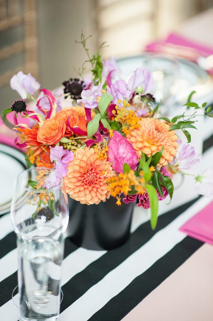 501 Union wedding with photos by Mikkel Paige Photography. The reception in Brooklyn, NY was lined with rectangular tables covered in pink linens, with vibrant flowers by August Sage and Violet and planning by Ashley Chamblin Events.
