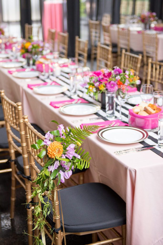 501 Union wedding with photos by Mikkel Paige Photography. The reception in Brooklyn, NY was lined with rectangular tables covered in pink linens, with vibrant flowers by August Sage and Violet and planning by Ashley Chamblin Events.