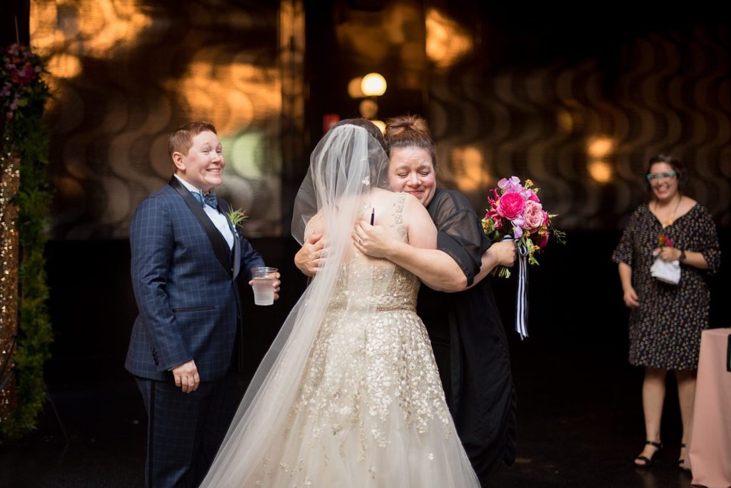501 Union wedding with photos by Mikkel Paige Photography. The bride hugs a friend right before the ceremony.