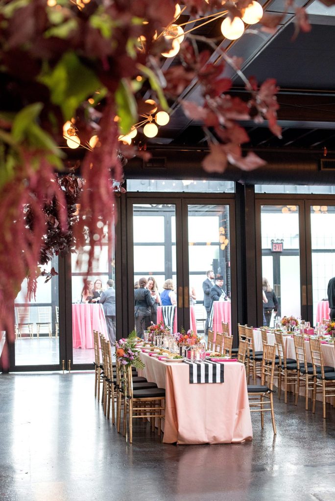 501 Union wedding with photos by Mikkel Paige Photography. The reception in Brooklyn, NY was lined with rectangular tables covered in pink linens, with vibrant flowers by August Sage and Violet and planning by Ashley Chamblin Events.