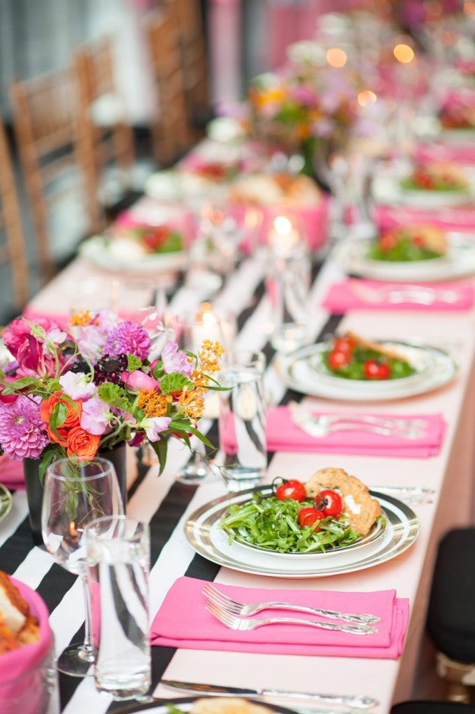 501 Union wedding with photos by Mikkel Paige Photography. The reception in Brooklyn, NY was lined with rectangular tables covered in pink linens, with vibrant flowers by August Sage and Violet and food by Ryan Brown Catering.