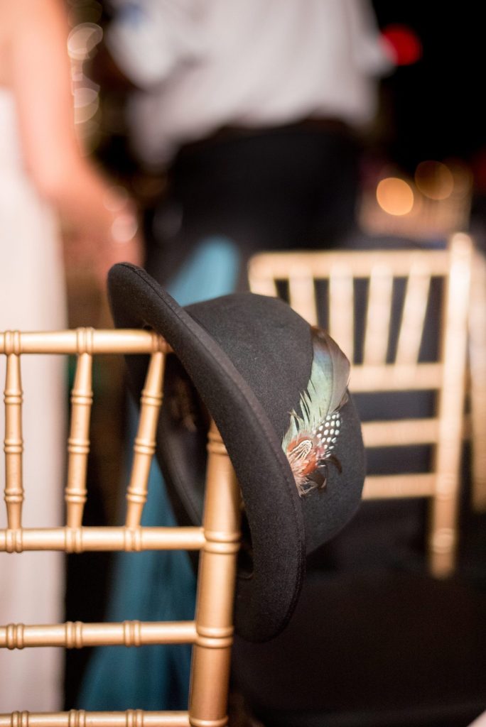 A picture of a guest's feathered hat during a 501 Union wedding reception. Photos by Mikkel Paige Photography.
