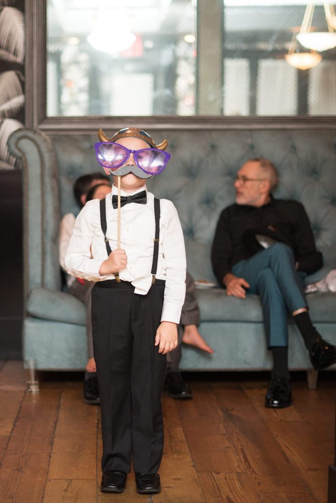 A picture of the ring bearer with a photo prop during a 501 Union wedding reception. Photos by Mikkel Paige Photography.