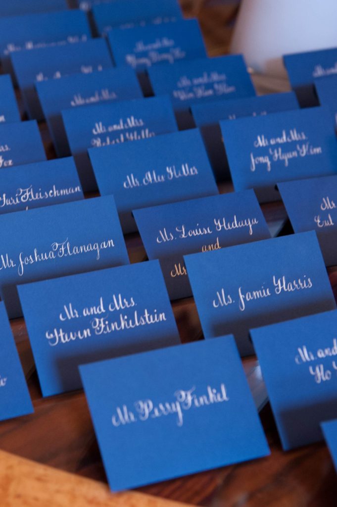Pictures of the escort card table with hand written calligraphy for a luxurious January wedding at the Crystal Plaza in NJ. Photos by Mikkel Paige Photography.