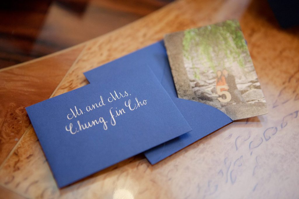 Pictures of the escort card table with hand written calligraphy for a luxurious January wedding at the Crystal Plaza in NJ. Photos by Mikkel Paige Photography.