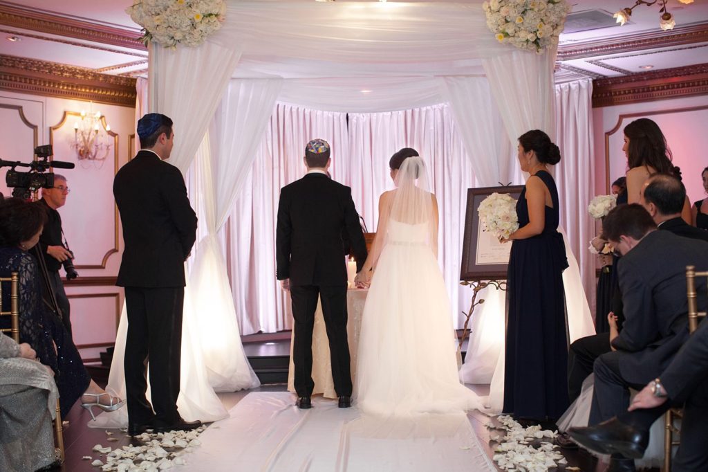 Pictures of an indoor ceremony for a luxurious January wedding at the Crystal Plaza in NJ. Photos by Mikkel Paige Photography.
