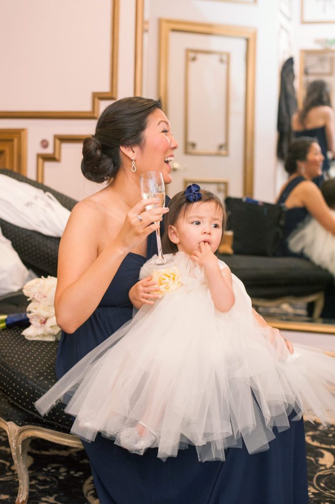 Picture of the bride's sister and flower girl in a tulle skirt during a winter wedding at the Crystal Plaza in NJ. Photos by Mikkel Paige Photography.