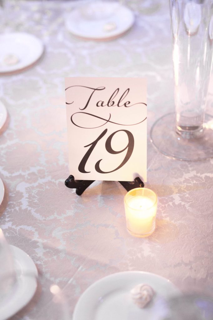 Script table numbers adorned the tables at a winter reception for a Crystal Plaza wedding in NJ. Photos by Mikkel Paige Photography.