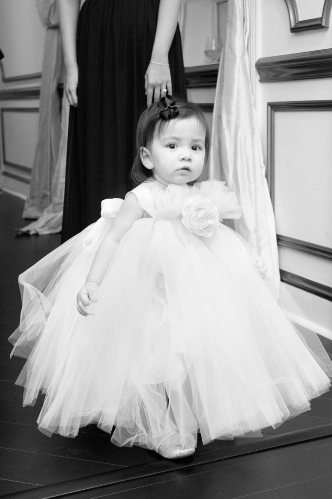A flower girl in tulle for a winter wedding at Crystal Plaza in New Jersey with photos by Mikkel Paige Photography.