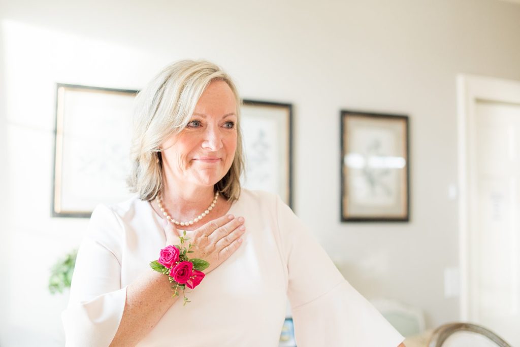 Fuquay-Varina wedding at Highgrove Estate in North Carolina with photos by Mikkel Paige Photography. The mother of the bride looks on as the groom and bride share their first look.