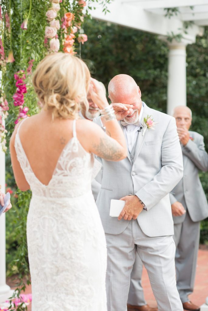 Fuquay-Varina wedding at Highgrove Estate in North Carolina with photos by Mikkel Paige Photography. The outdoor ceremony was covered in petals and flowers by Flowers on Broad Street.