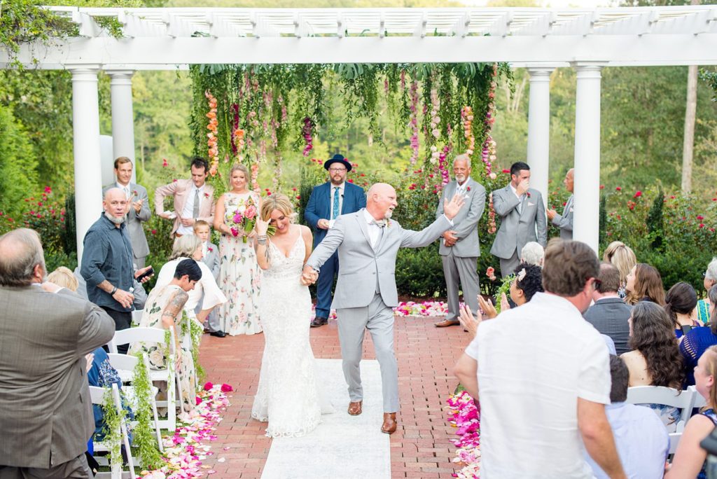 Fuquay-Varina wedding at Highgrove Estate in North Carolina with photos by Mikkel Paige Photography. The outdoor ceremony was covered in petals and flowers by Flowers on Broad Street. Planning by A Southern Soiree.