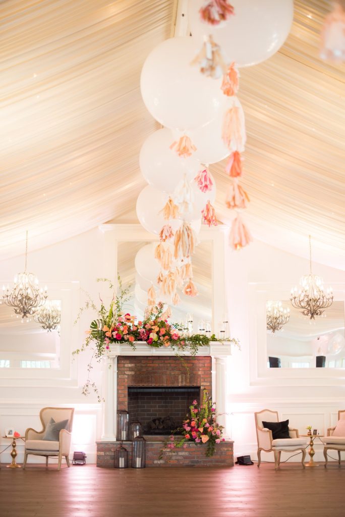 Fuquay-Varina wedding at Highgrove Estate in North Carolina with photos by Mikkel Paige Photography. Planning by A Southern Soiree. Lounge furniture rentals from Greenhouse Picker Sisters and huge balloons and tissue paper tassels adorning the ceiling.