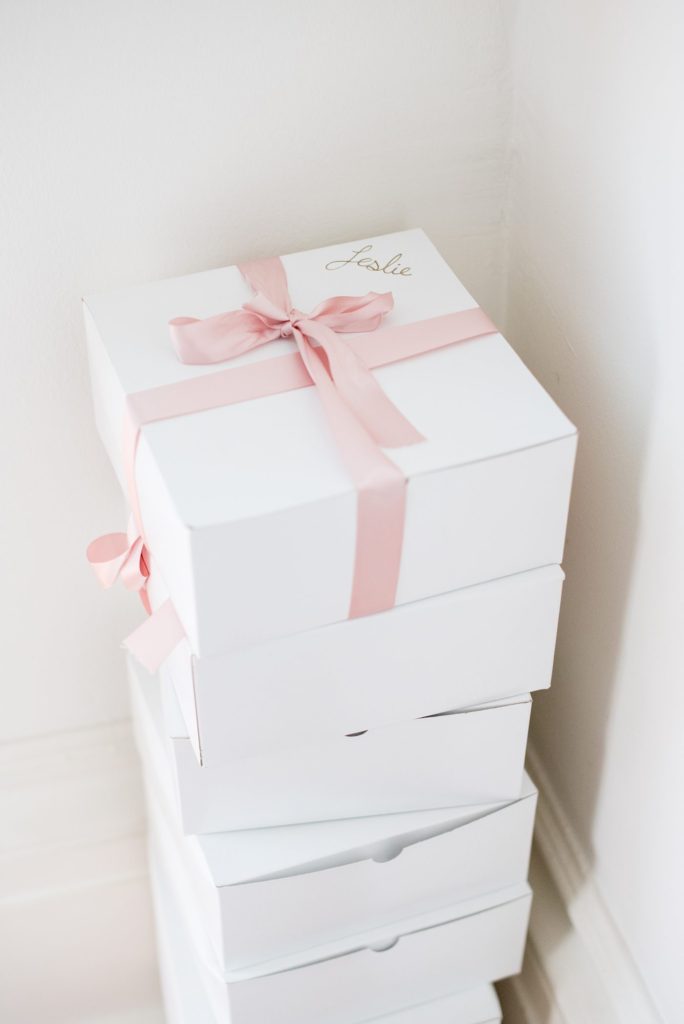 A Hudson Valley wedding in upstate New York, photographed by Mikkel Paige Photography. Planning by The Union Studio. The bride gave gift boxes to her bridal party wrapped in pink ribbon.