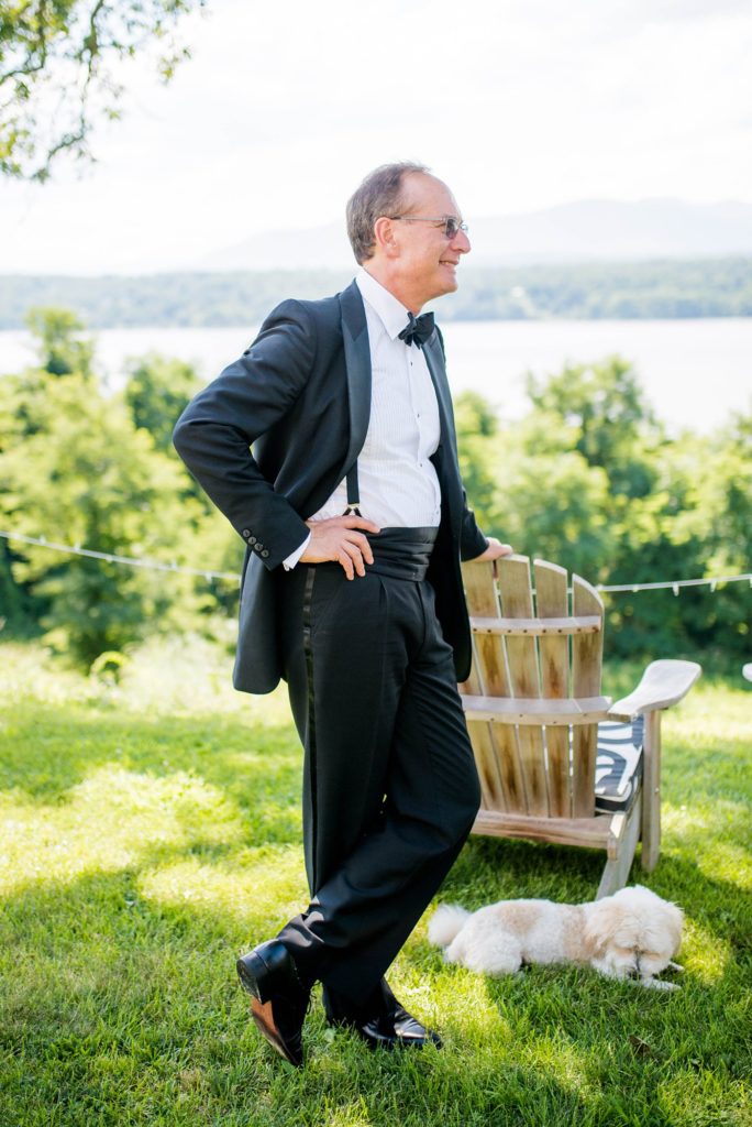 The father of the bride looks on for his daughter's summer celebration at Southwood Estate. This Hudson Valley wedding was photographed by Mikkel Paige Photography and planned by The Union Studio.