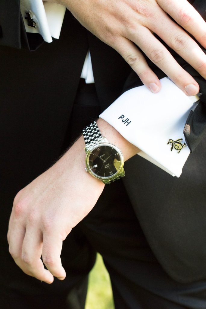 The groom had monogrammed cuffs on his wedding day shirt and penguin cufflinks for his Hudson Valley wedding at Southwood Estate. Photography by Mikkel Paige and planning by The Union Studio.