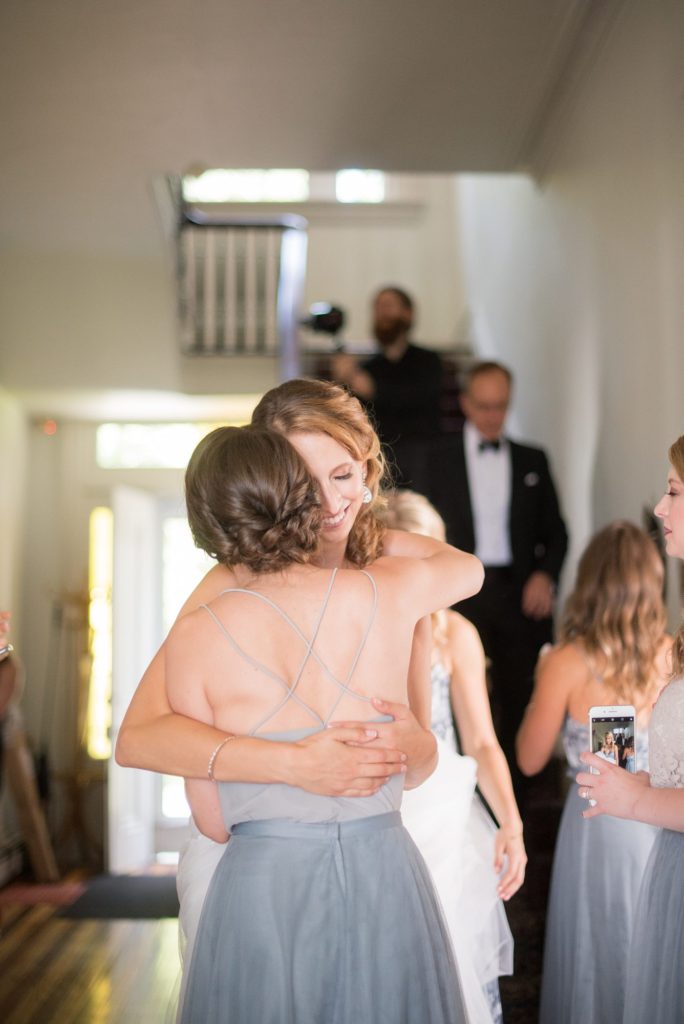 Southwood Estate was the setting for a Hudson Valley Weddings. Photo by Mikkel Paige Photography of the bride hugging her bridesmaid before the ceremony.