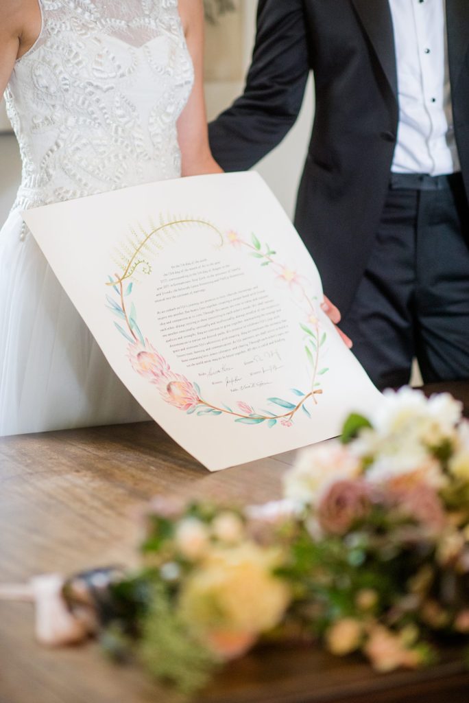 The bride and groom signed the ketubah at their Jewish ceremony for their Hudson Valley wedding at Southwood Estate. Photos by Mikkel Paige Photography.