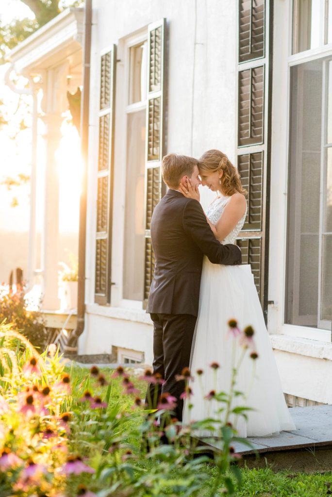 Bride and groom share a moment during golden hour captured by Mikkel Paige Photography at Southwood Estate overlooking the Hudson River in the valley, in upstate New York.