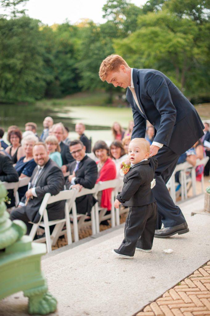 Mikkel Paige Photography captures a Prospect Park Boathouse wedding in Brooklyn, New York. The bride and groom had an outdoor ceremony overlooking the park lake with the toddler ring bearer leading the way.