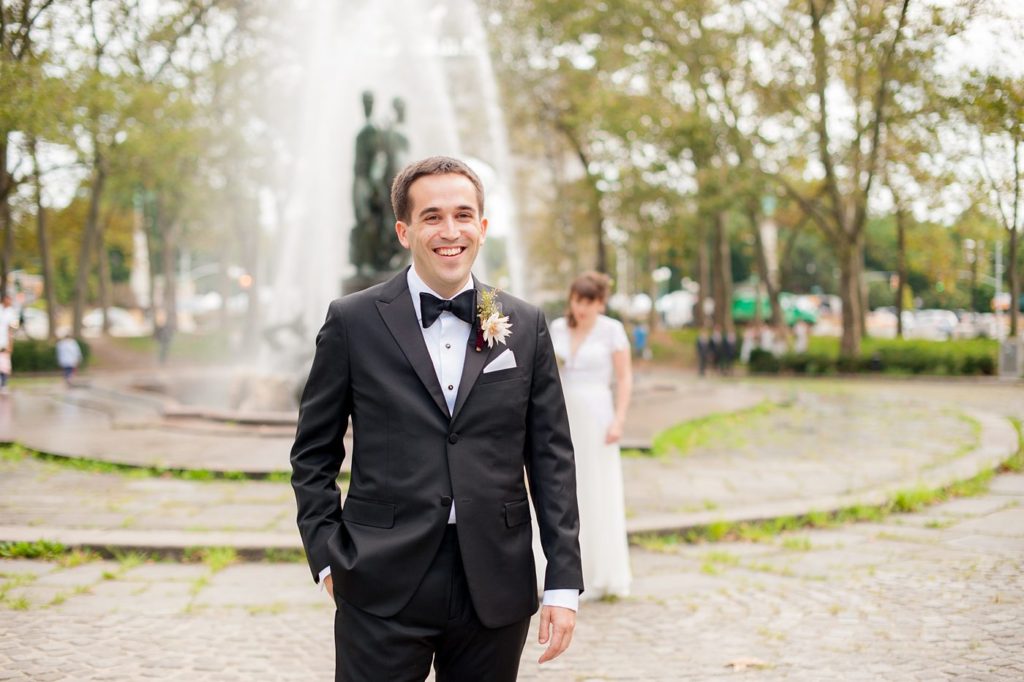Mikkel Paige Photography photos of the bride and groom's first look at Grand Army Plaza for their Prospect Park Boathouse wedding in Brooklyn, New York. Bouquet created by Sachi Rose Designs.