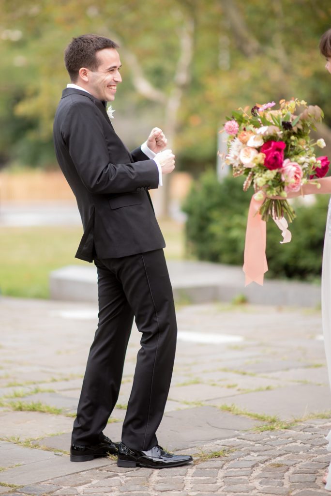 Mikkel Paige Photography photos of the bride and groom's first look at Grand Army Plaza for their Prospect Park Boathouse wedding in Brooklyn, New York. Bouquet created by Sachi Rose Designs.