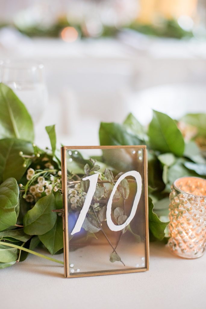 Prospect Park Boathouse wedding in Brooklyn, New York. Photo of the glass table number frames at the reception by Mikkel Paige Photography.