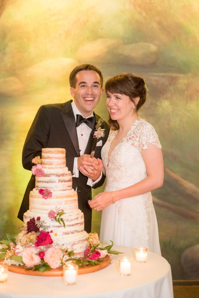 Prospect Park Boathouse wedding in Brooklyn, New York. Photos by Mikkel Paige Photography as the bride and groom cut the cake during their reception.