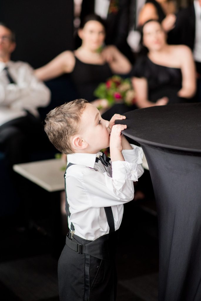 Photos of the ring bearer at a W Hoboken Wedding by Mikkel Paige Photography. Floral design by Sachi Rose.