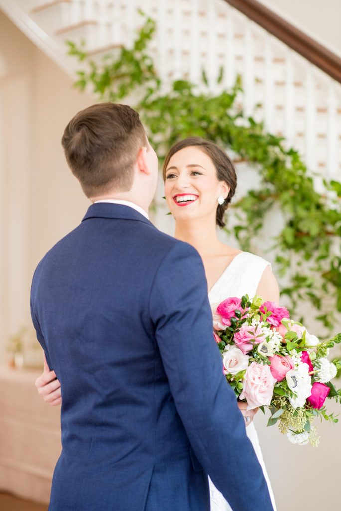 The bride and groom share their first look at Merrimon-Wynne House. Their luxury wedding was photographed by Mikkel Paige Photography. Floral comb by Eclectic Sage.