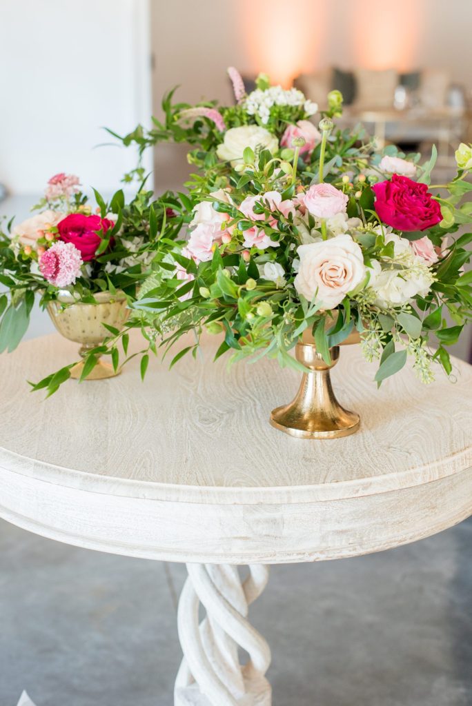 Photography of the ceremony setup for a colorful ceremony by Mikkel Paige Photography. Floral arrangements created by Eclectic Sage for a wedding venue in Raleigh NC, Merrimon-Wynne.