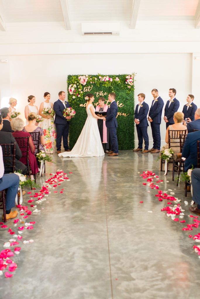 A photo of a colorful ceremony setup at Merrimon-Wynne house, captured by Mikkel Paige Photography. This downtown wedding venue in Raleigh, NC is partially indoors and outdoors.