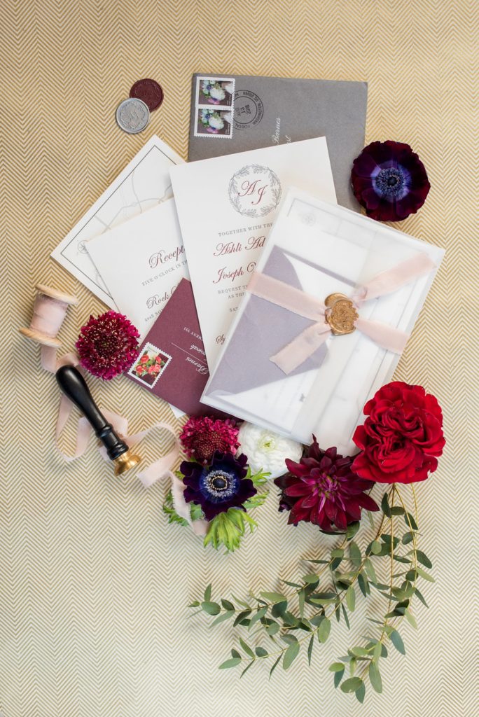 Flat lay styling for destination weddings and events by Mikkel Paige Photography. This stationery suite was for a fall luxury wedding with berry tones.