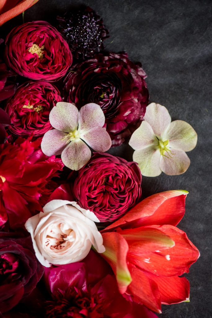 Flat lay styling for destination weddings and events by Mikkel Paige Photography. This flower styling was part of a spring luxury wedding with berry tones and high contrast at the W Hotel in Hoboken, New Jersey.