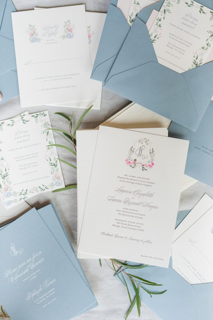 A stationery suite with hand painting and blue envelopes for flat lay photography.