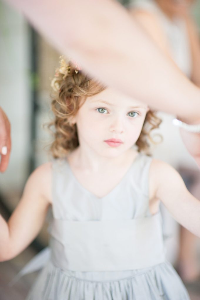 Hamptons wedding photographer captures two grooms for a same sex wedding at a private home. Flower girl image by Mikkel Paige Photography.